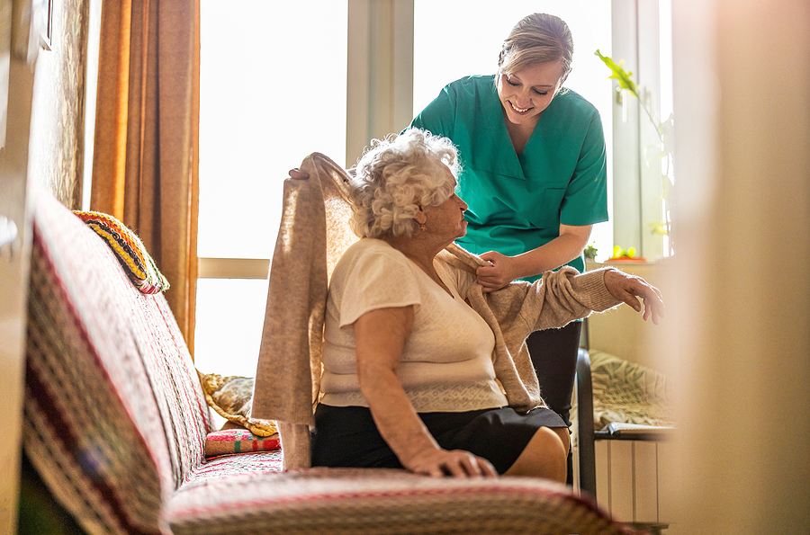 Senior receiving personal care assistance from certified caregiver through in-home care services in Texas
